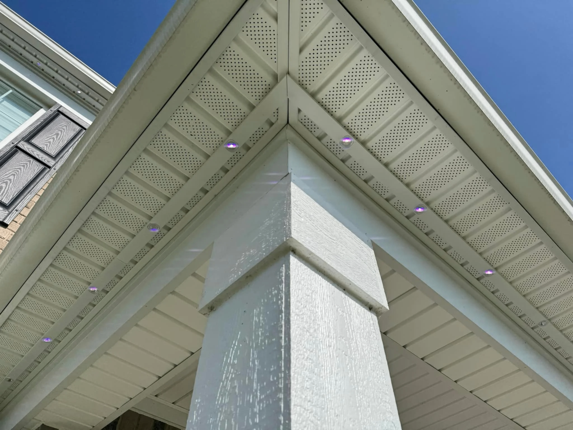 Aluminum channel installed beneath a soffit in daylight