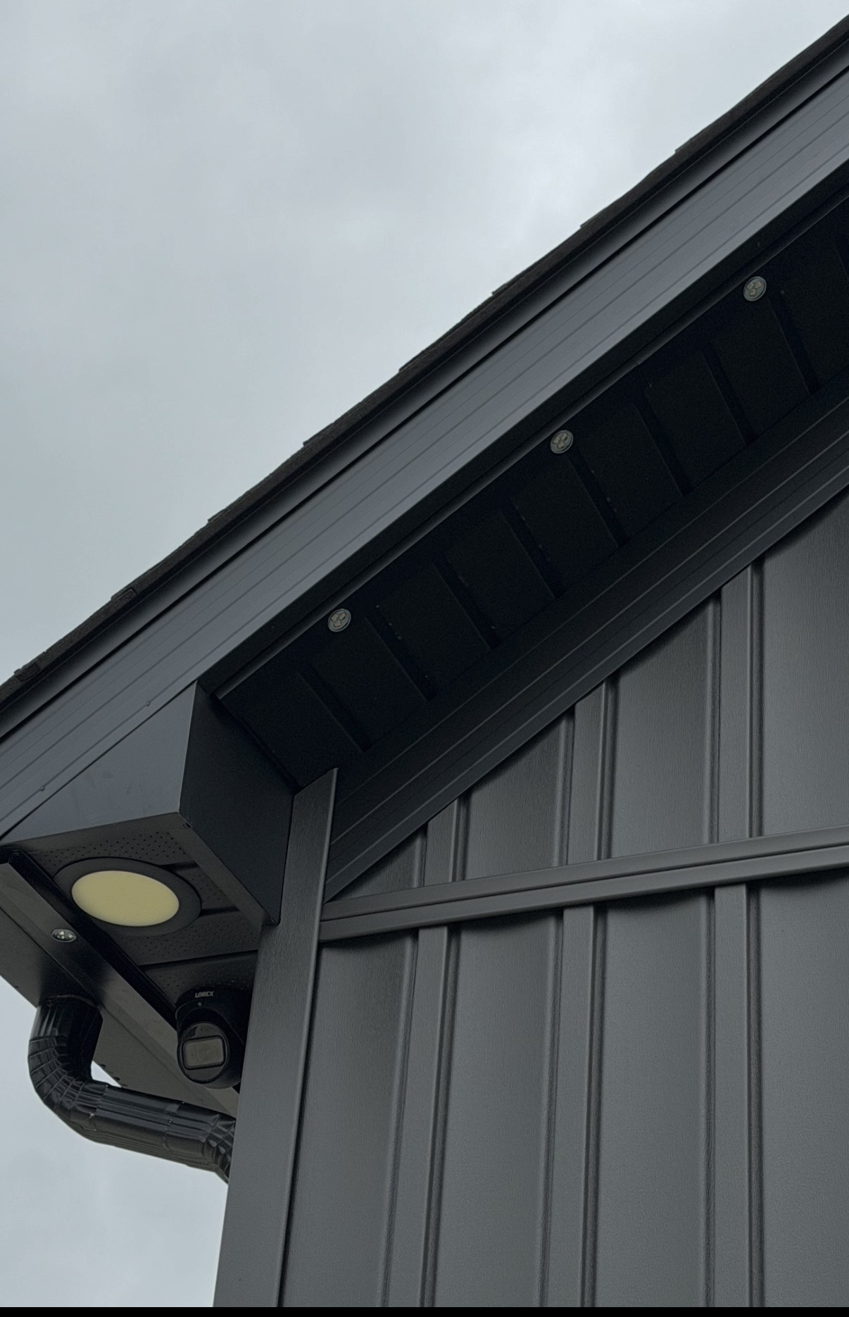 Permanent LED points installed flush beneath a dark soffit in daylight