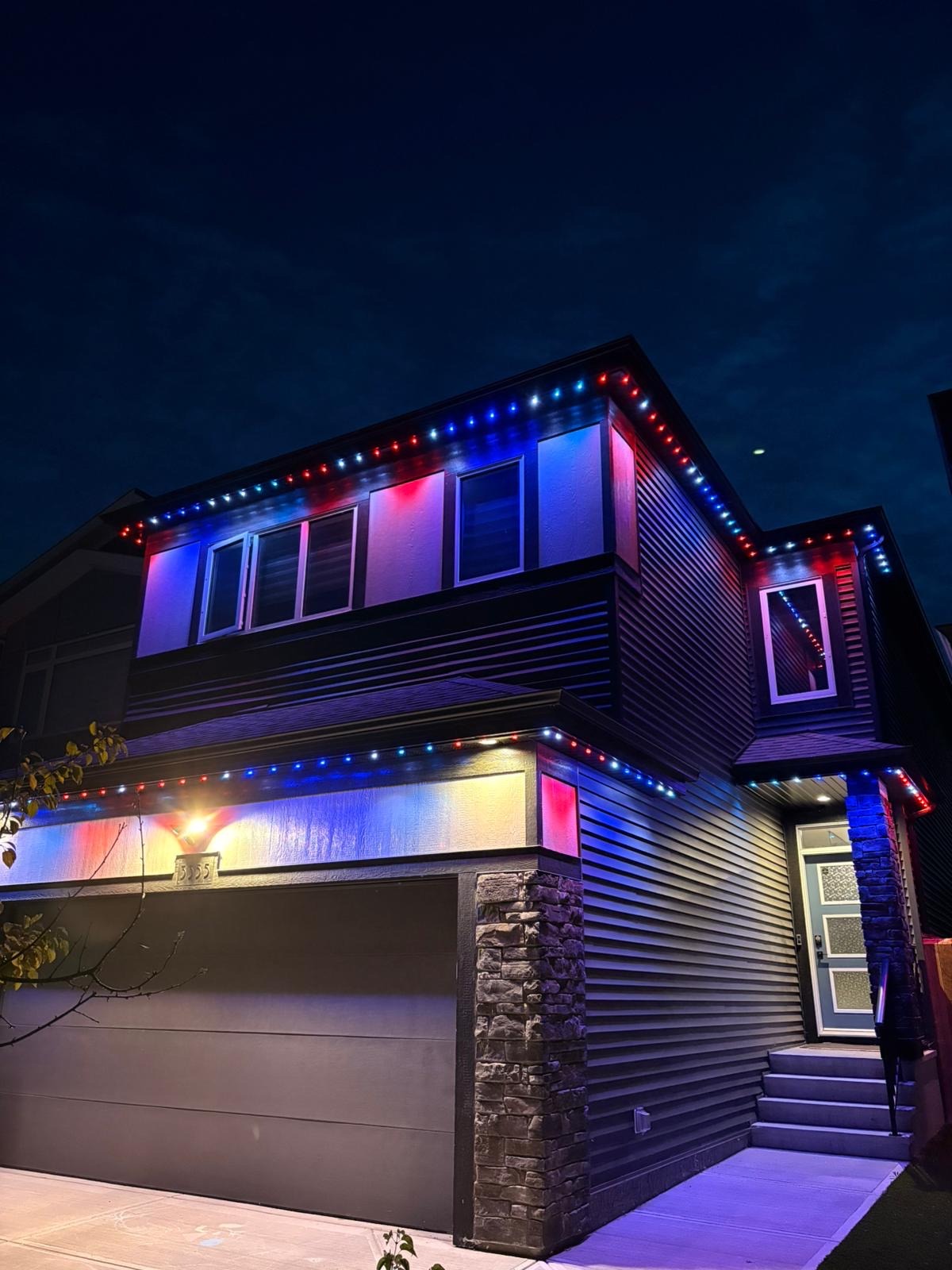Home lit in red, white, and blue for the 4th of July